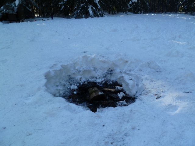 There were several of these fire pits the second time. I'm not sure how much the fire melted the snow versus how much they had to actually dig, but we spent a good fifteen minutes trying to fill in a hole on the sliding hill that wasn't there last time. Bumps much smaller than this pit have . . . severe consequences.